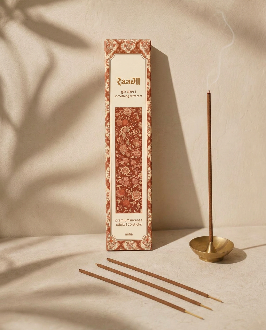RAAGA incense box with sticks burning in a brass holder